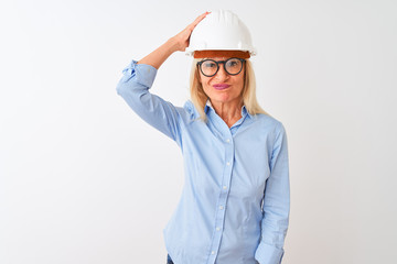 Middle age architect woman wearing glasses and helmet over isolated white background confuse and wonder about question. Uncertain with doubt, thinking with hand on head. Pensive concept.
