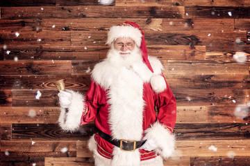 Smiling real Santa Claus with gold bell. - obrazy, fototapety, plakaty