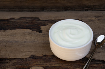 Obraz na płótnie Canvas Yogurt In white glass wood background from top view.