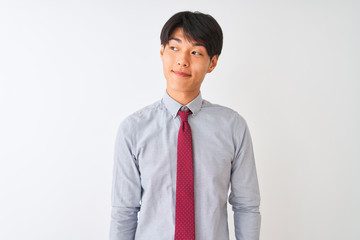 Chinese businessman wearing elegant tie standing over isolated white background smiling looking to the side and staring away thinking.