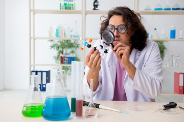 Funny male chemist working in the lab