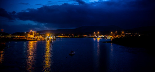 Obraz premium Lights, ships and boats in a Castletownbere harbor at night