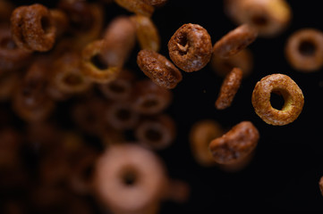 morning breakfast, round chocolate. frozen in the air on a black background for design