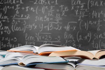 Many open books lying flat before a