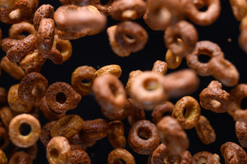 morning breakfast, round chocolate. frozen in the air on a black background for design