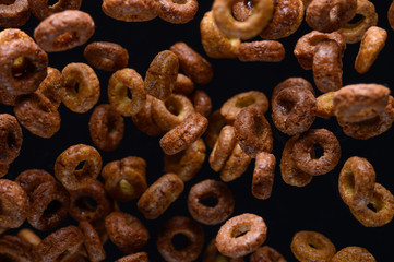 morning breakfast, round chocolate. frozen in the air on a black background for design
