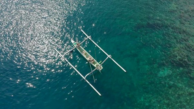 aerial shot of a fishing boats that bring divers to the diving spots on a tropical island