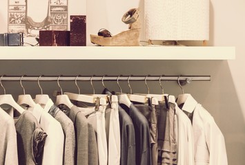 Modern clothes on metal hangers in closet