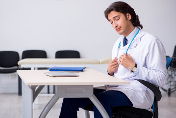 Young doctor being tired after night shift