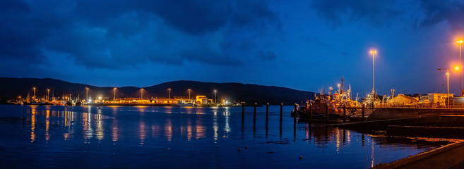 Fototapeta na wymiar Lights, ships and boats in a Castletownbere harbor at night