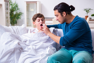 Young father caring for sick son