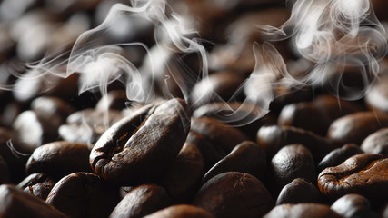 bevergae background of a roasted coffee bean on background of coffee beans with aromatic smoke
