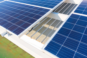 Obraz premium Solar panels and blue sky background.Solar cells farm on the roof.Photovoltaic modules for renewable energy.Save the earth and the energy with good environment concept.