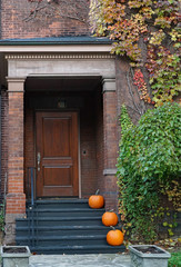 Front steps of house with pumpkins for Halloween