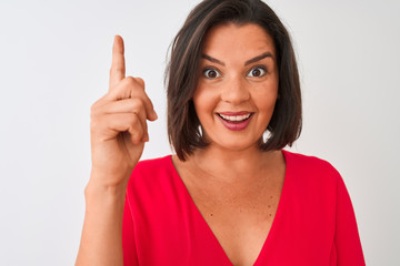 Young beautiful woman wearing red t-shirt standing over isolated white background surprised with an idea or question pointing finger with happy face, number one