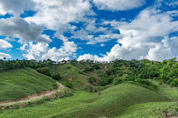 Naklejka premium Mountains view, tropical landscape, palm trees, sky scape, sunlight through clouds, Dominican Republic 