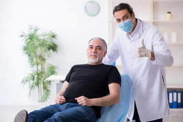 Fototapeta premium Old man visiting young doctor for plastic surgery