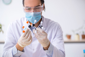 Young male chemist working in the lab