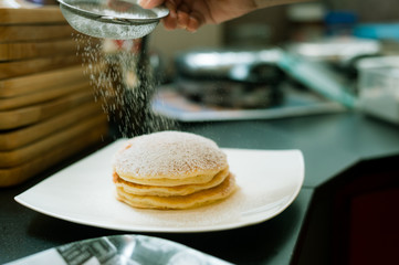 three pancakes with banana in white dish
