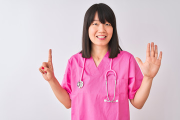 Young beautiful Chinese nurse woman wearing stethoscope over isolated white background showing and pointing up with fingers number six while smiling confident and happy.