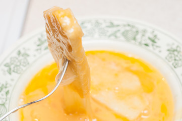 Soaking the cut bread in the egg mixture. Salvation of old bread from stale and flowering. Cooking croutons from bread and chicken eggs.