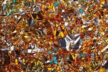 Golden christmas tinsel close-up isolated top view