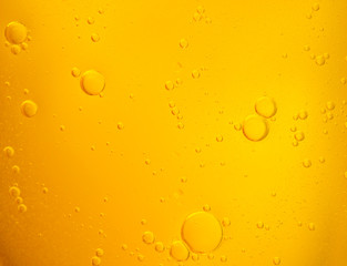 Bubbles on beer background. Oil drop shape on yellow background.Golden circle bubble water pattern.
