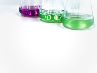 The Erlenmeyer or Conical flask on bench laboratory, with green-purple solvent forming reaction...