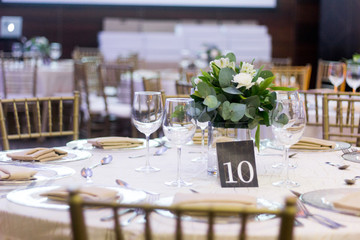 Elegant table at event with ornaments and flowers.