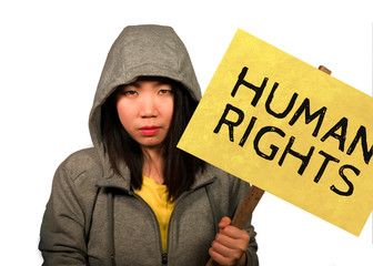 young beautiful Asian Chinese student woman as protestor and pacifist holding protest billboard...