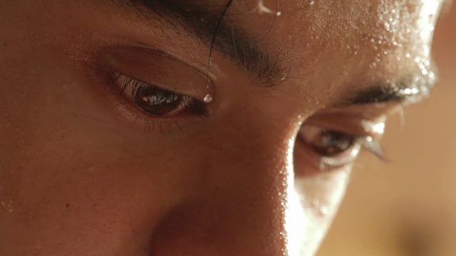 Closeup of sweating teenage boy intensely working by writing and doing mental calculations