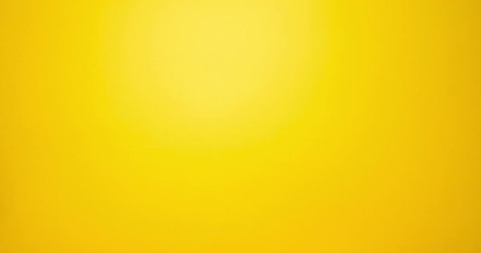 Woman hand show thumbs down gesture. Female hand over yellow background