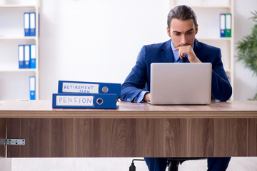 Young male accountant working in the office