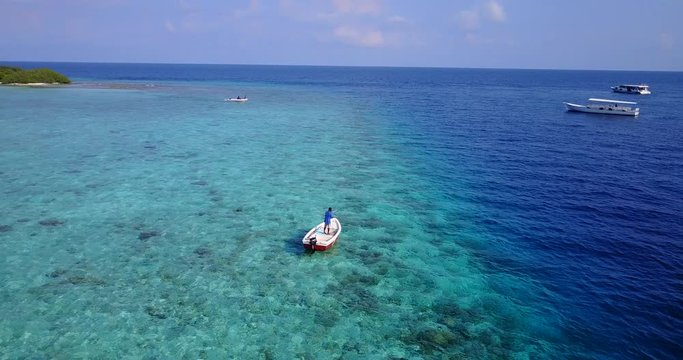 Dynamic view of the  boats sailing near the  tropical island