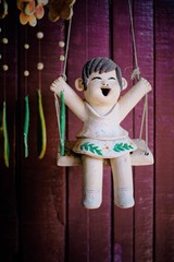 The statue of the girl laughing on the swing