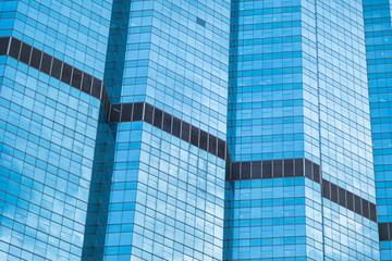 Fototapeta na wymiar Blue glass windows of modern office building