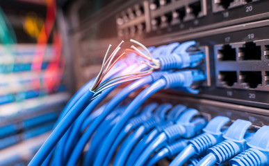 damaged stranded network cable is located on the background of the server room. Problem with...