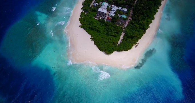 Flight over tropical island with palm trees, white sand beach and crystal clear turquoise water , Dominican Republic