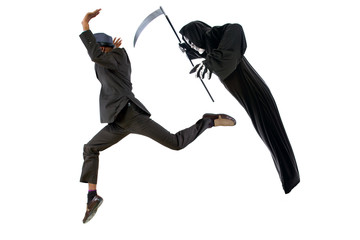 Man in a grim reaper halloween ghost costume having fun and scaring a grown businessman in a suit. ...