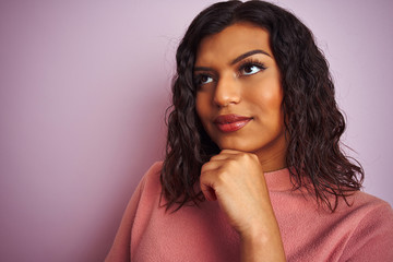 Young beautiful transsexual transgender woman standing over isolated pink background serious face thinking about question, very confused idea