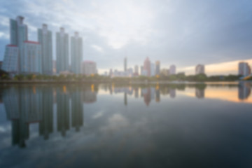 Fototapeta premium Blur City building with water reflection before sunset