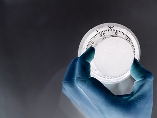 Hand is rotating the security code of safe