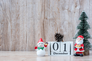 1 December calendar with Christmas decoration, snowman, Santa claus and pine tree  on wooden table...
