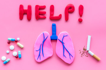 Treat lung diseases. Word help, organ and pills on pink background top view