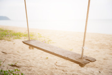 Wood swing at the beach and sand