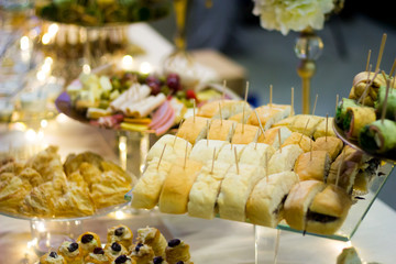fancy elegant desert table with lot of sweets and candies.