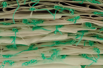 A group of plastic sacks with light blue strings. Pile of empty sacks, texture background.