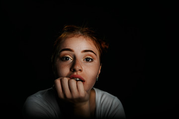 Young girl looks enthusiastically with open mouth and expression of surprise on her face.