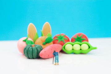 Miniature toys studio set up - a farmer looks at his produce.