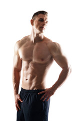 Fototapeta premium Strong, fit and sporty bodybuilder man over white background. Sport and fitness.